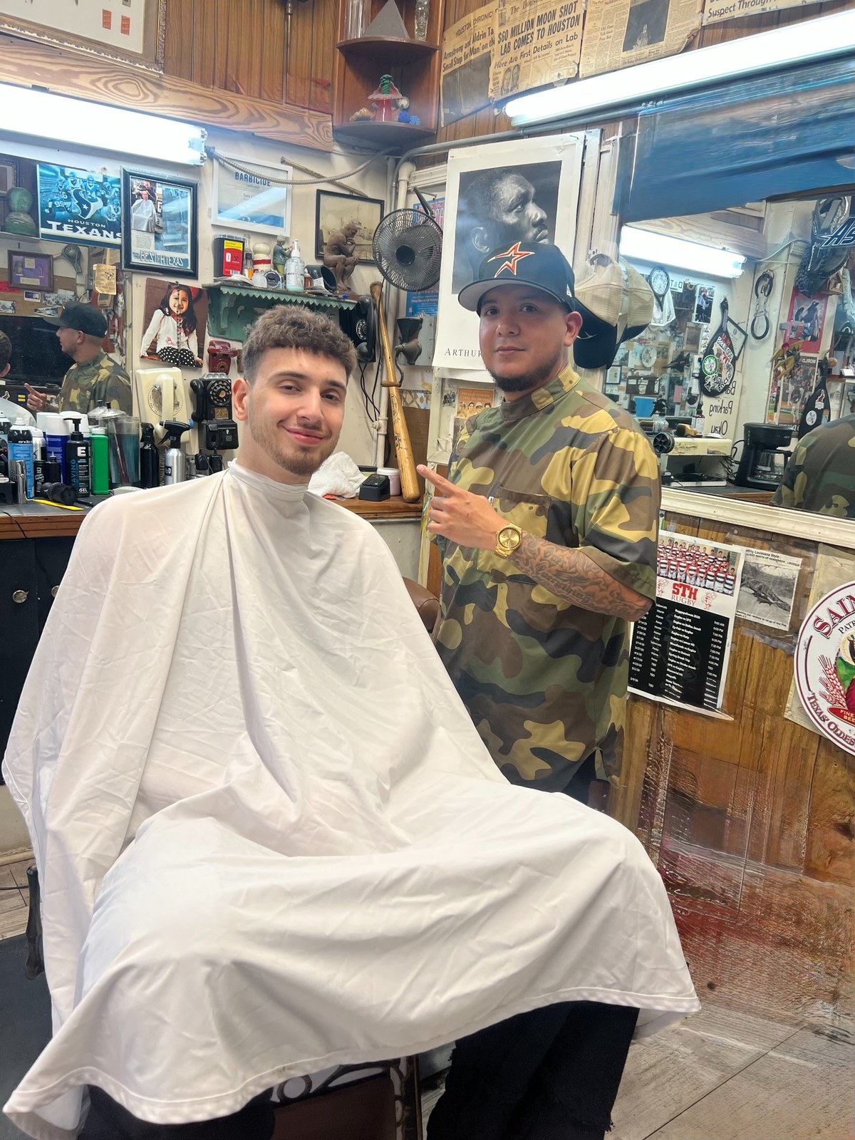 Barber standing beside a client in the barber chair