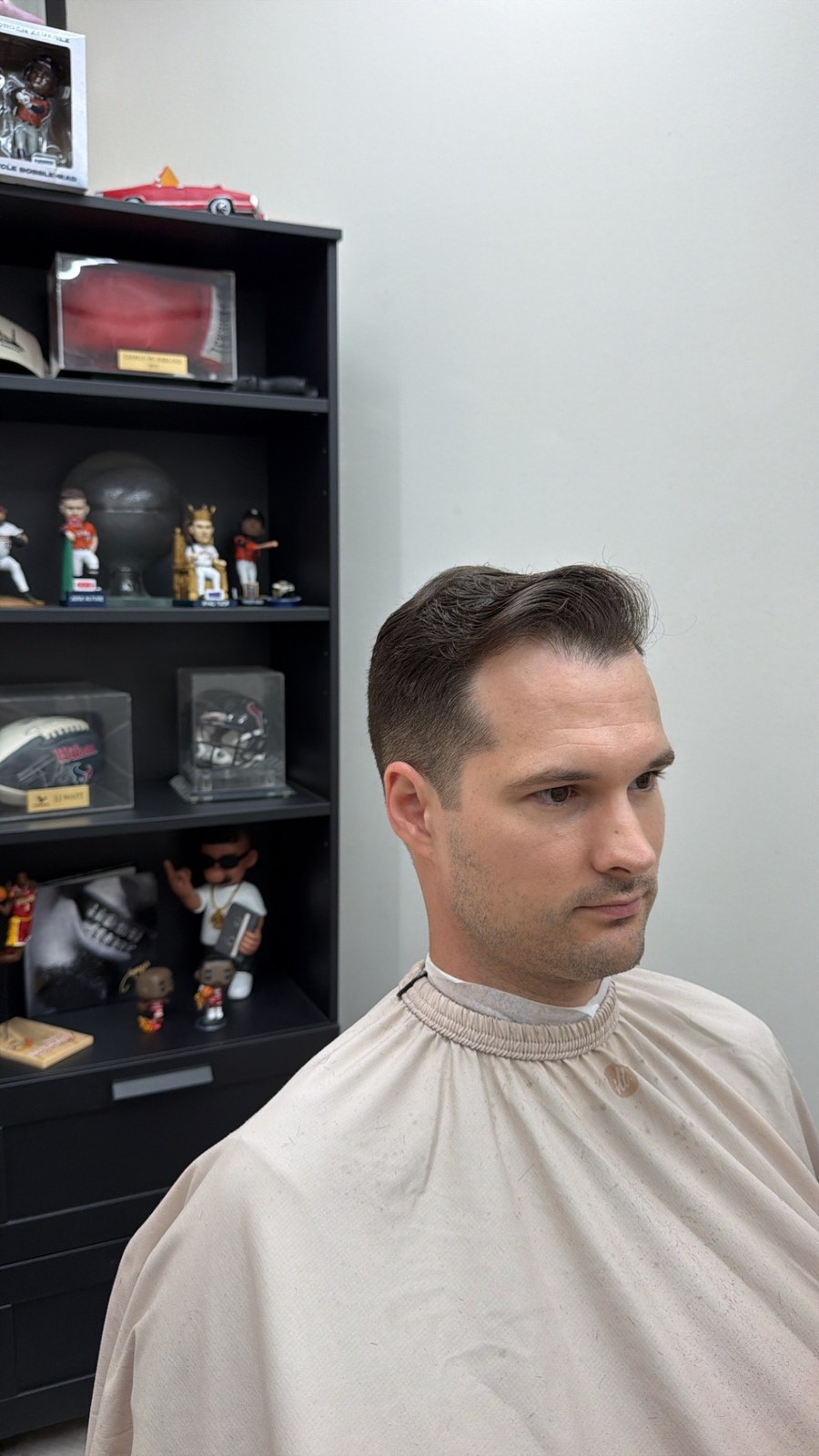 Swept-back haircut with neatly tapered sides