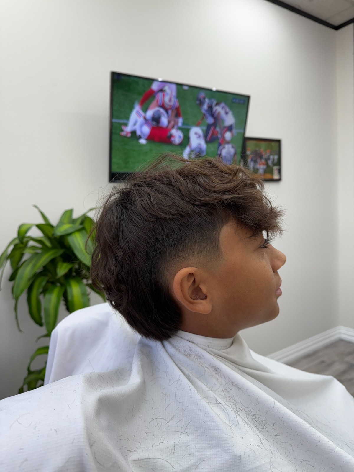 Long textured haircut with closely tapered sides